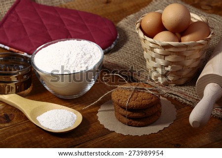 Ingredients and appliances for baking on wooden table top, horizontal picture