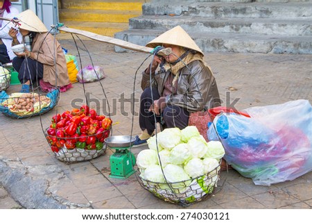 Vietnamese vendors selling fruit and vegetables at Dalat city market, Vietnam