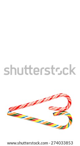 Traditional Christmas red and white and multicolored candy cane over white background