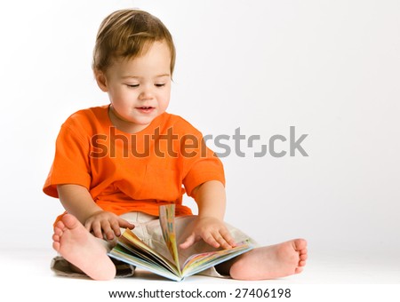 Little girl sits and reading book