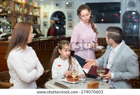 Cafe guests sitting at table and showing service discontent. Selective focus  Royalty-Free Stock Photo #274070603