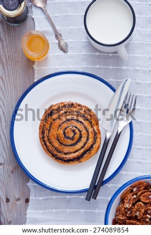 Puff scroll pastry, Sliced poppy seed roll,  Sweet poppy seed bun on a white plate