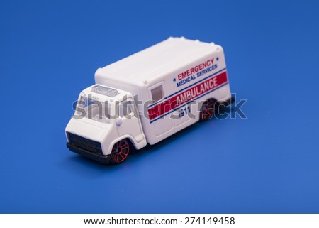 Toy ambulance car isolated on blue background