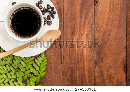 Cup of coffee on a wooden table, background