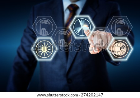 Torso of a corporate manager in business suit reaching out to touch a wind power icon. The active wind symbol is lighting up together with a solar and geothermal energy button. Energy turn metaphor. Royalty-Free Stock Photo #274202147