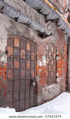 Old brick wall with rusty closed door