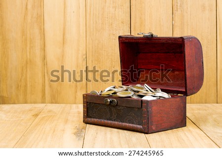 saving coin thai bath in wood box on wooden background