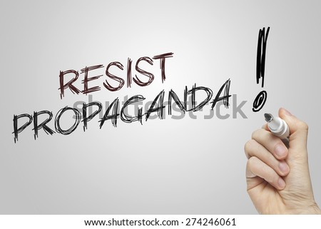 Hand writing resist propaganda on grey background