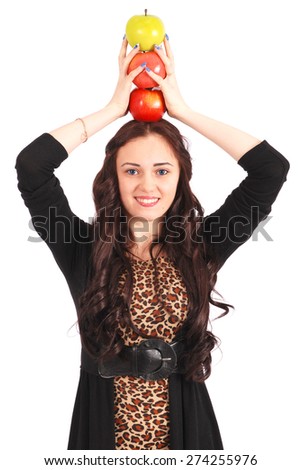 Teen girl holds an three apples on her head isolated on white