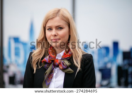 Blonde, expressive business woman looking pleased