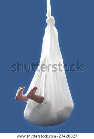 newborn child hanging from cloth over blue background Royalty-Free Stock Photo #27428827