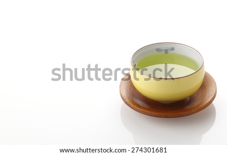 Japanese green tea in porcelain cup on white background