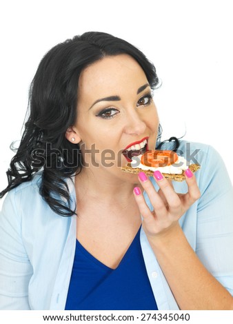 Young Healthy Woman Eating a Cracker with Cottage Cheese and Tomato