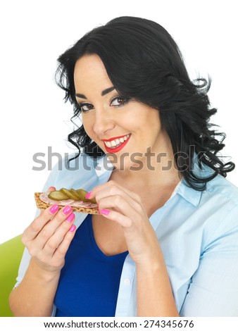 Young Healthy Woman Eating a Cracker with German Sausage and Gherkin