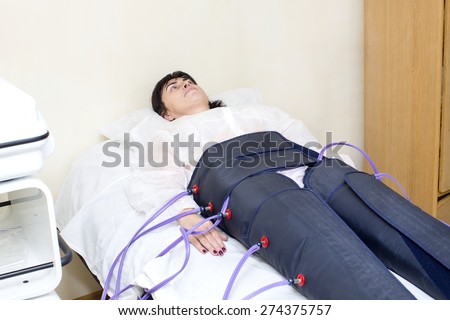 woman at the clinic for the treatment of pressure therapy procedure