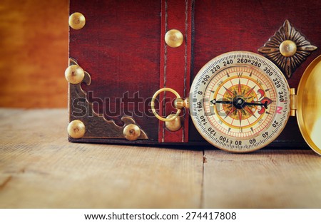 antique compass on wooden table