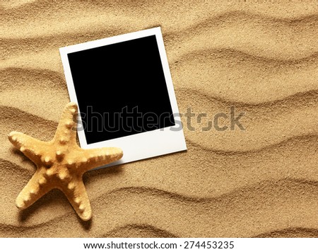 Old style empty photo card on sea sand sunny background. Close up