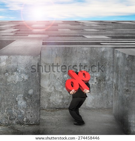 Man carrying big 3D red percentage sign entering the huge maze with blue sky clouds background