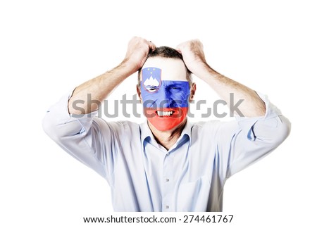 Mature man with Slovenia flag painted on face.
