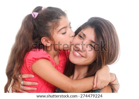 portrait of a little girl kissing her mother on a white background