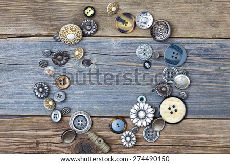 several vintage buttons on the aged table surface with copy space
