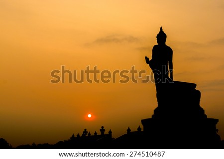 Buddha at sunset. When the evening sun is bright red. Lord Black is a sleek backlit. Public Art