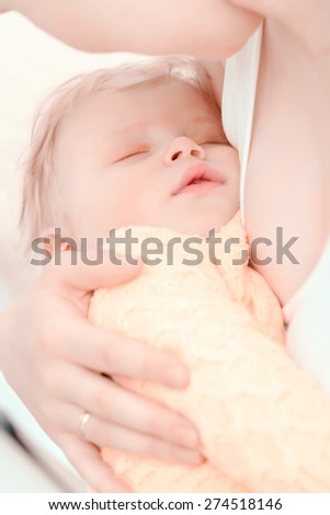 Carefree childhood .Small baby boy sleeping on the chest of his happy mother