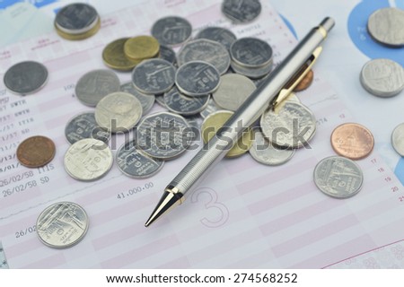 Pen and coin on saving book, accounting background