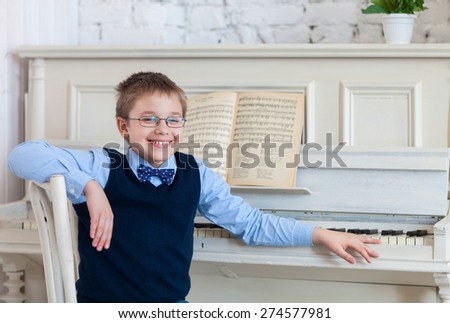 Little boy playing piano at home. Concept of music 