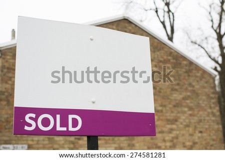 Blank SOLD sign outside a building, space for text to be added