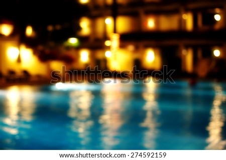 blur yellow golden light reflection in swimming Christmas luxury pool party water at night background   Royalty-Free Stock Photo #274592159