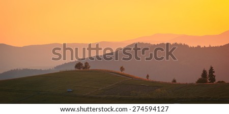 Sunset landscape with colorful silhouettes of mountains range. Carpathian mountains. Ukraine.