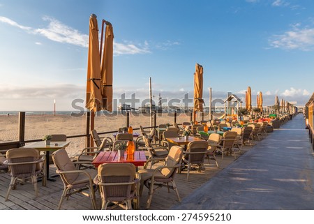 Terraces along the Dutch beach with a view at the famous Pier of Scheveningen Royalty-Free Stock Photo #274595210