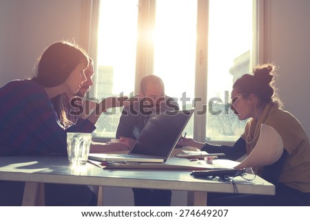 Young group of people/architects discussing business plans. Royalty-Free Stock Photo #274649207