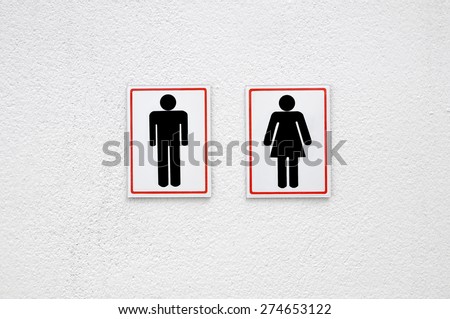 Man and lady toilet sign on white concrete wall background 