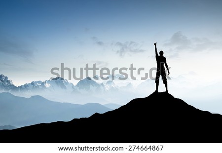 Winner silhouette on the mountain top. Sport and active life concept Royalty-Free Stock Photo #274664867