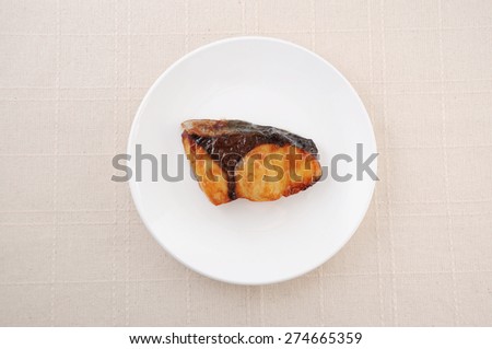 broiled teriyaki fish Japanese amberjack on plate on table