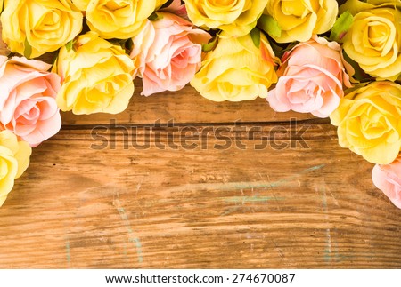 Colorful roses flowers, floral background on a vintage wooden planks background for mothers day, wedding invitation, greetings card and invitation cards