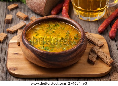 Chicken noodle healthy broth soup with croutons on vintage background Royalty-Free Stock Photo #274684463