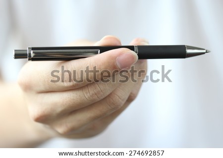  hand gift pen to you for choose ,Close up Human Hand Signing on Formal Paper at the Table on Black Background