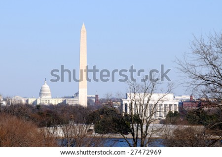 Skyline of Washington DC in winter, including the Capitol, the Washington Monument, and the Lincoln Memorial, as seen from Arlington, Virginia, across the Potomac River.