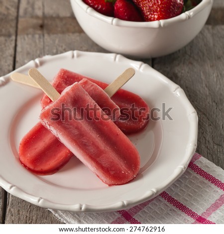 Frozen Strawberry Fruit Bars on old wooden background. Selective focus.