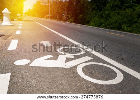 Bicycle lane sign on asphalt road in Thailand.
