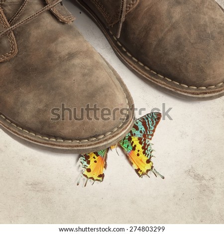 Textured grunge old paper background with boots crushing a butterfly. Ecological negative concept