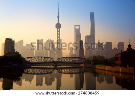 Shanghai skyline at sunrise with historical Waibaidu bridge, China