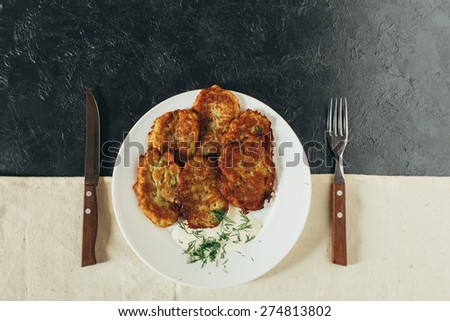 Tasty potato pancakeson on a black background
