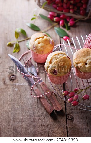 Berry muffins, cutlery and fresh berries on a rustic dark wooden background. Selective focus, shallow depth of field