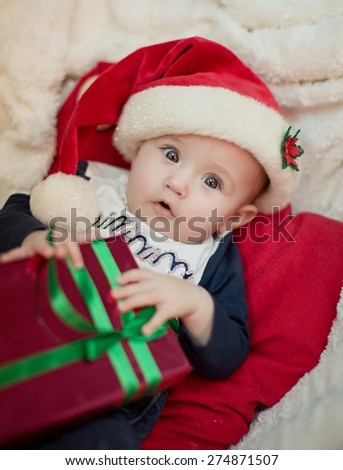 Christmas little baby girl with Santa hat and gift