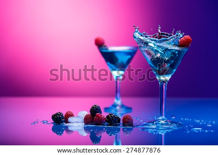 Colorful cocktails garnished with berries Royalty-Free Stock Photo #274877876