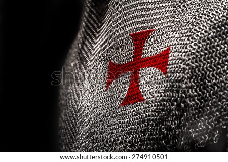 Medieval chainmail armour with a red cross on chest area Royalty-Free Stock Photo #274910501